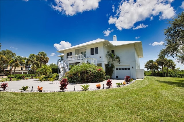 view of front of property with a garage and a front yard