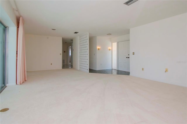 unfurnished living room featuring light carpet