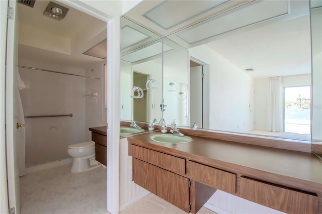 bathroom with vanity, toilet, and tile patterned floors