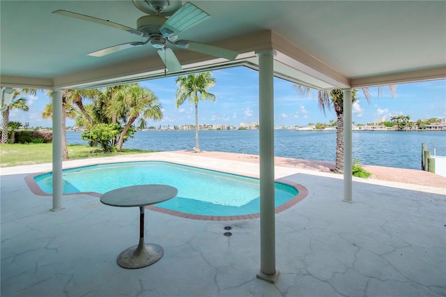 view of swimming pool with a water view, ceiling fan, and a patio area