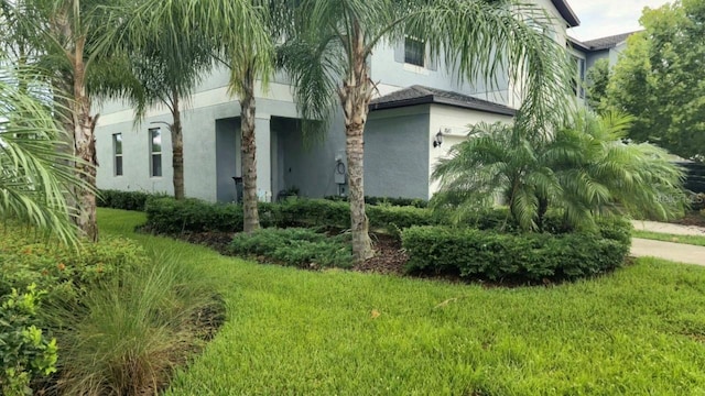 view of property exterior with a lawn