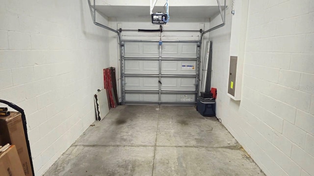 garage with a garage door opener and electric panel