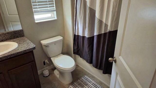 bathroom featuring vanity, tile patterned flooring, a shower with curtain, and toilet