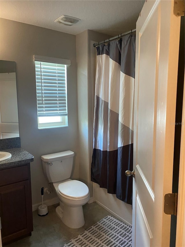 bathroom with tile patterned flooring, toilet, and vanity