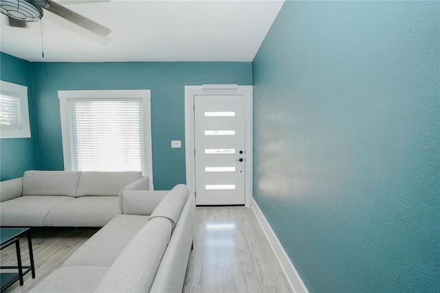 living room featuring ceiling fan and light wood-type flooring