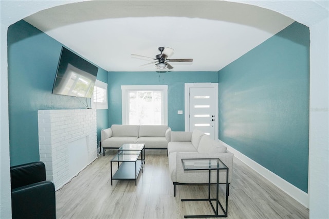 living room featuring ceiling fan and light hardwood / wood-style floors