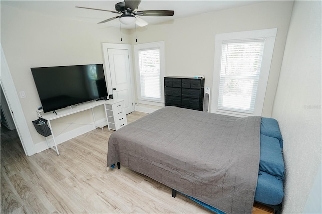 bedroom with ceiling fan and hardwood / wood-style floors