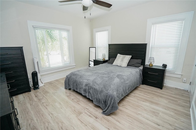 bedroom with ceiling fan and light hardwood / wood-style floors