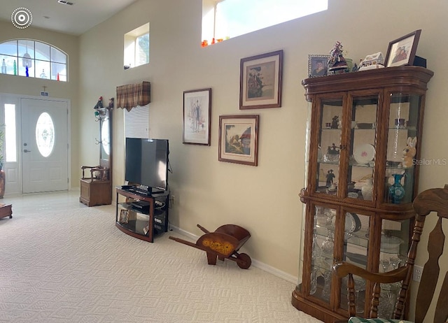 interior space featuring a healthy amount of sunlight and a high ceiling