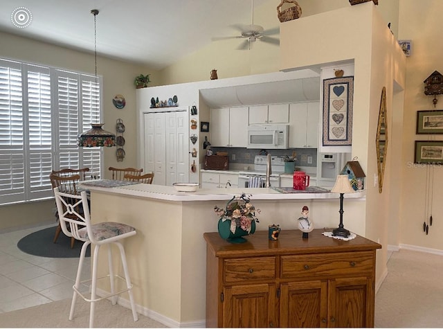 kitchen featuring electric stove, ceiling fan, white cabinets, decorative backsplash, and light colored carpet