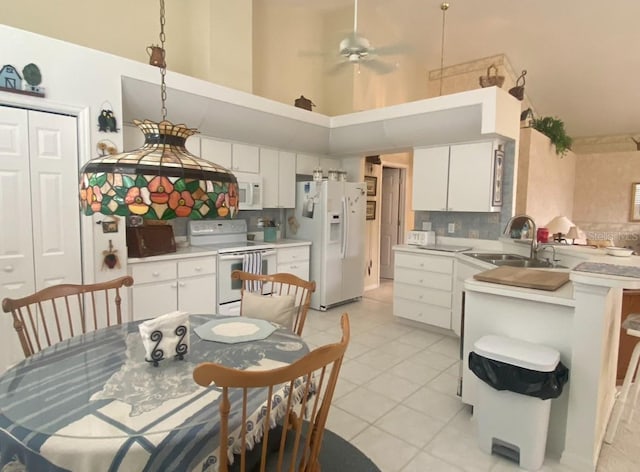 interior space featuring a high ceiling, sink, ceiling fan, and light tile patterned floors