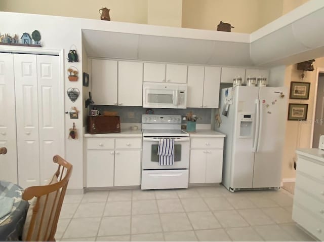 kitchen featuring white cabinetry, white appliances, backsplash, and light tile patterned floors