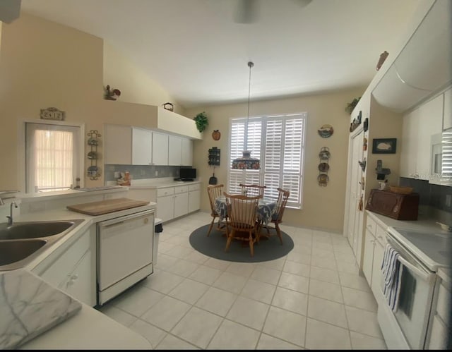 kitchen with white cabinets, white dishwasher, light tile patterned floors, and stove