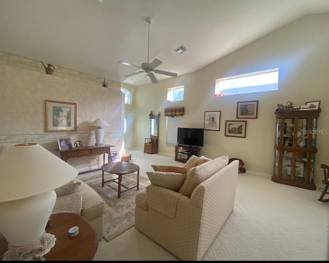 living room featuring light carpet, ceiling fan, and vaulted ceiling