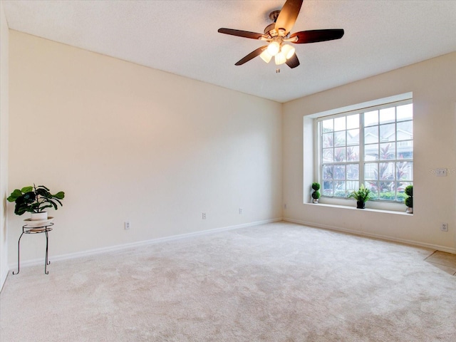 carpeted empty room featuring a textured ceiling and ceiling fan