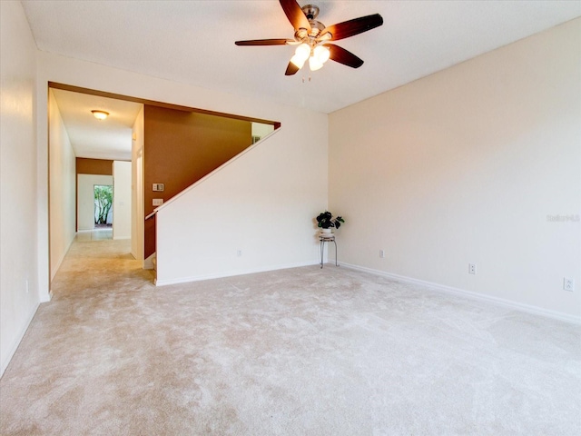 unfurnished room featuring light carpet and ceiling fan