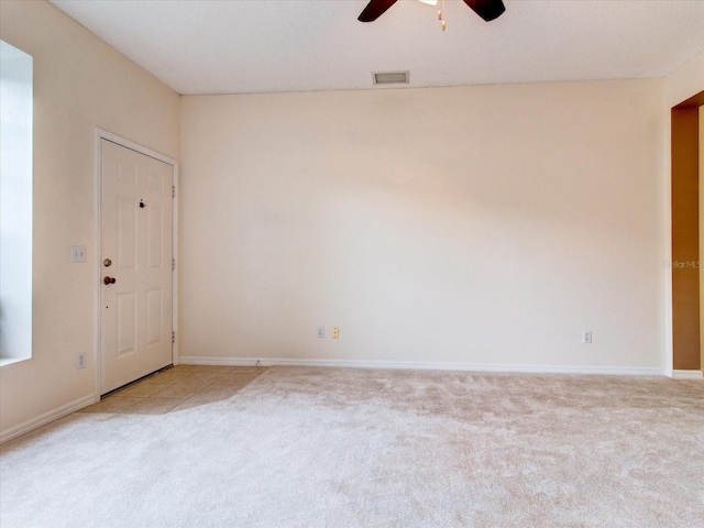 carpeted empty room featuring ceiling fan