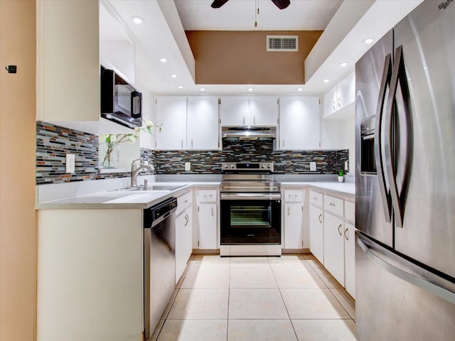 kitchen with white cabinets, tasteful backsplash, appliances with stainless steel finishes, and ceiling fan