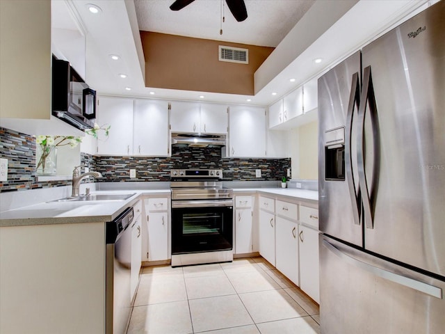 kitchen with decorative backsplash, appliances with stainless steel finishes, ceiling fan, and white cabinetry