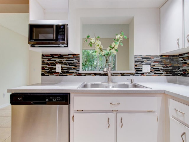 kitchen with decorative backsplash, stainless steel appliances, white cabinetry, and sink