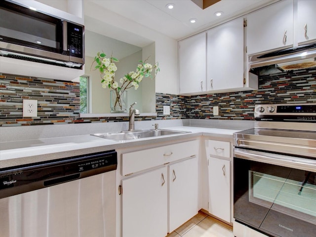 kitchen featuring decorative backsplash, stainless steel appliances, and white cabinetry