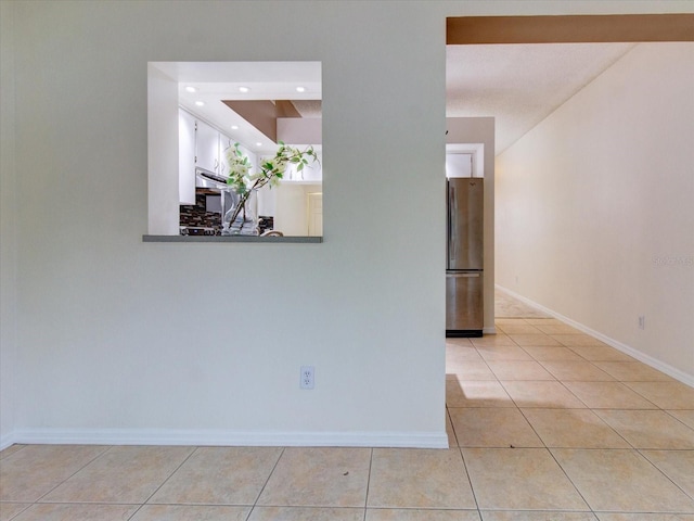 hall with light tile patterned floors