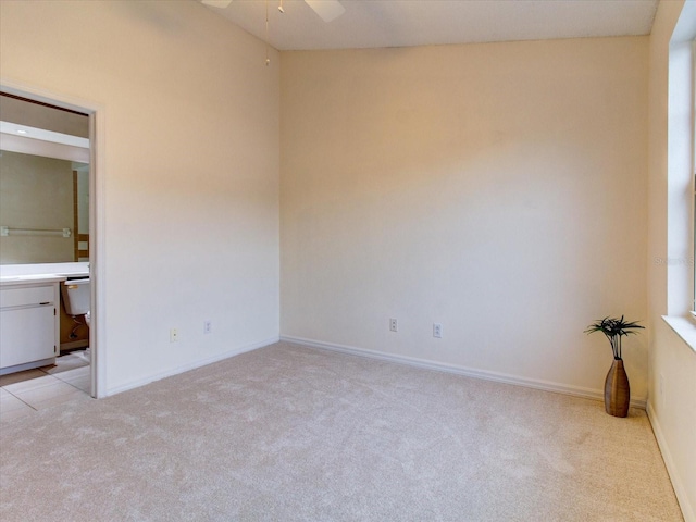 unfurnished bedroom featuring light carpet and ceiling fan