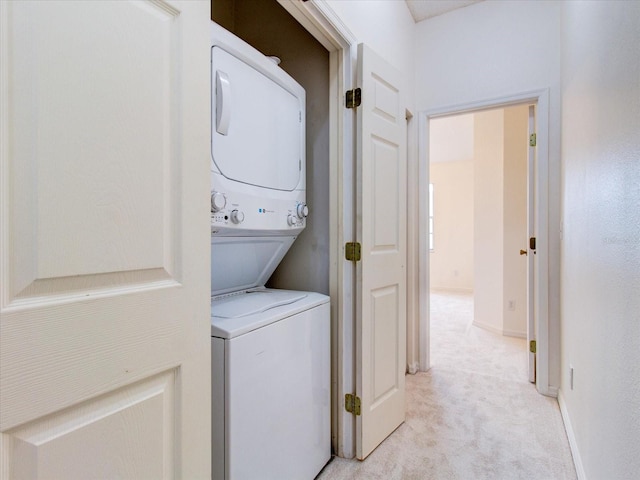 washroom with light carpet and stacked washing maching and dryer