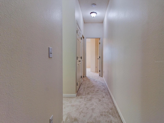 corridor with light colored carpet