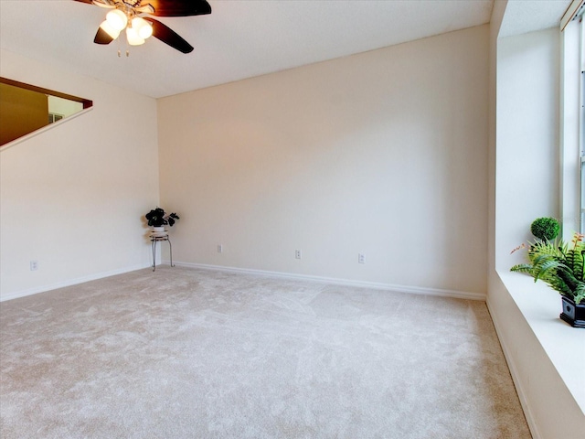 carpeted empty room featuring ceiling fan