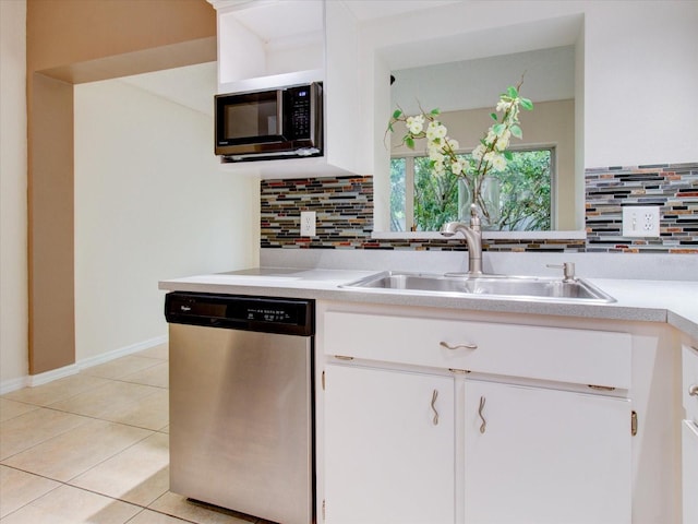 kitchen featuring appliances with stainless steel finishes, white cabinets, and backsplash