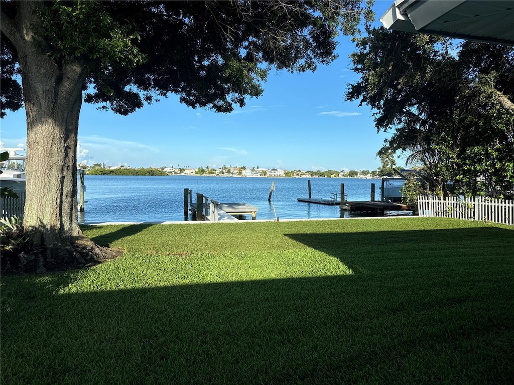 view of yard with a water view and a boat dock