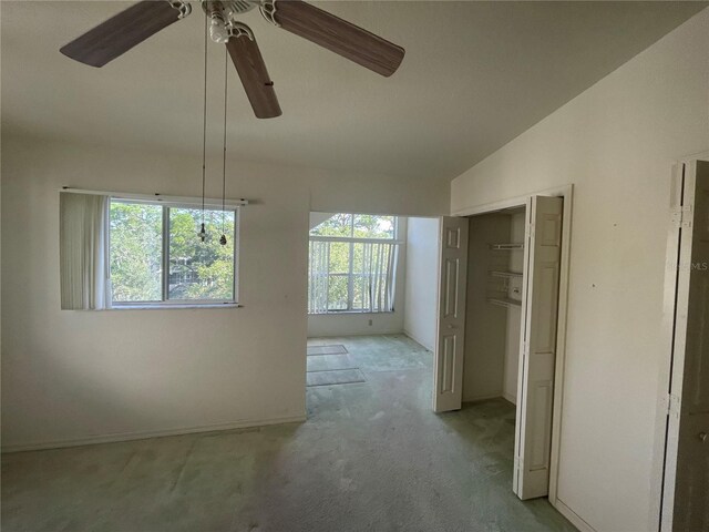 interior space with ceiling fan, lofted ceiling, and a healthy amount of sunlight