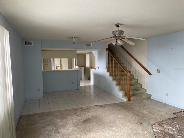 unfurnished living room with ceiling fan and light tile patterned floors