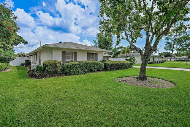 view of side of property with a lawn