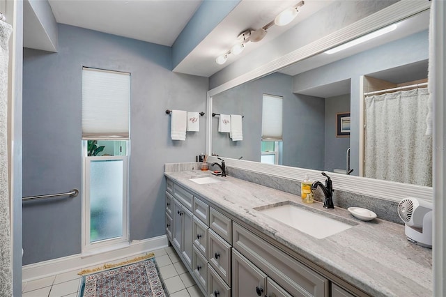 bathroom with a wealth of natural light, tile patterned flooring, and vanity