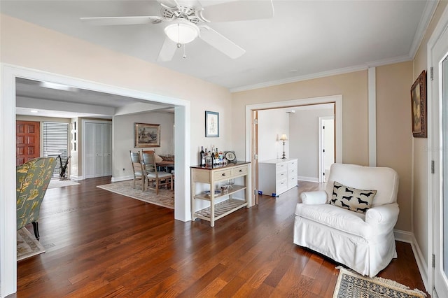 sitting room featuring ceiling fan, dark hardwood / wood-style floors, and crown molding