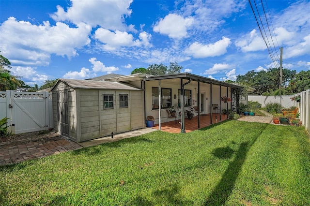 rear view of property featuring a patio area and a yard