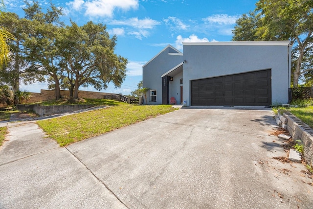 contemporary home with a garage and a front yard