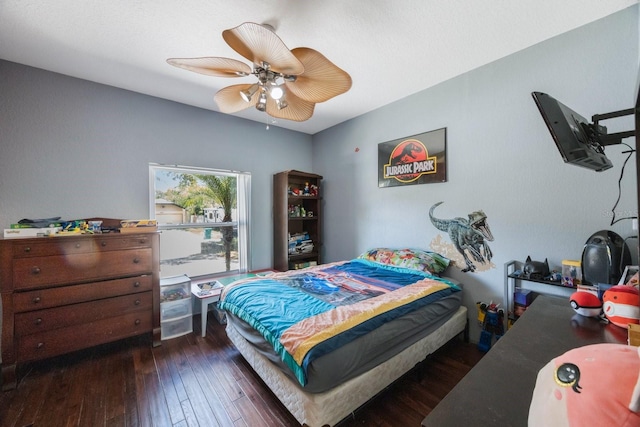 bedroom with dark hardwood / wood-style flooring and ceiling fan