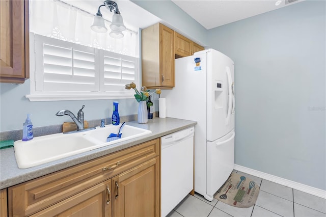 kitchen featuring light tile patterned flooring, white dishwasher, and sink