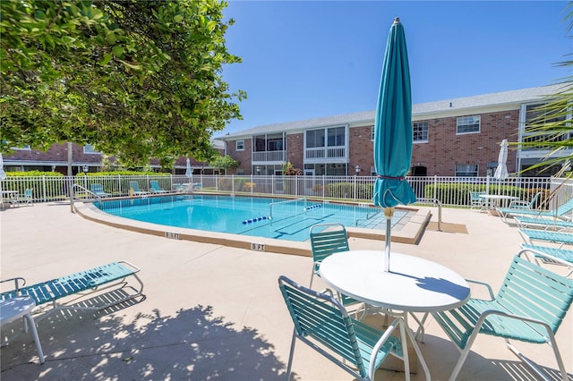 view of swimming pool featuring a patio area