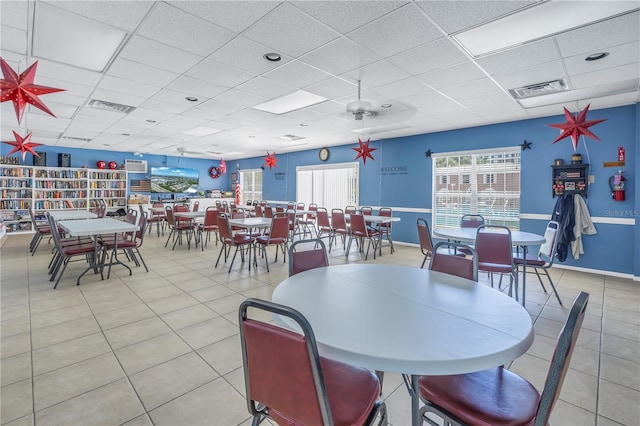 tiled dining space featuring a paneled ceiling