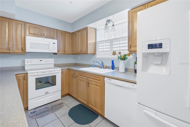 kitchen with sink, light tile patterned flooring, and white appliances