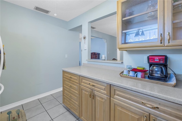 kitchen featuring light tile patterned flooring and a textured ceiling