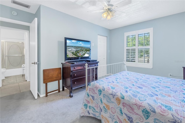 bedroom featuring light carpet, a textured ceiling, and ceiling fan