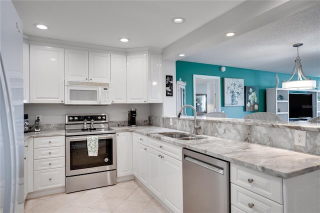 kitchen featuring kitchen peninsula, appliances with stainless steel finishes, white cabinets, and sink