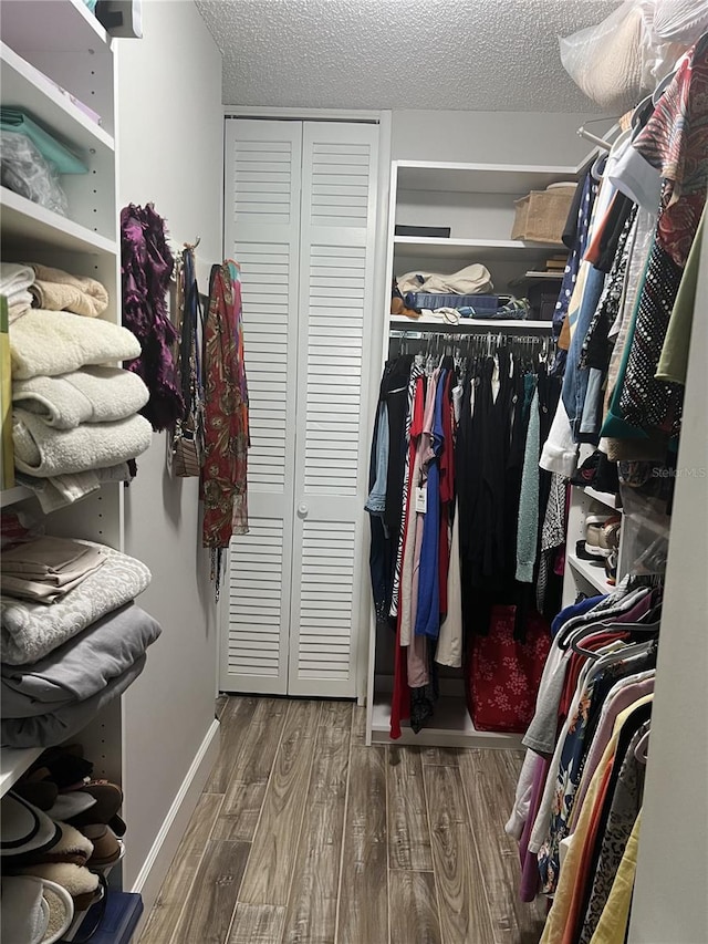 walk in closet featuring hardwood / wood-style floors