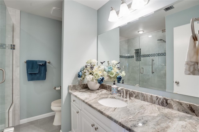 bathroom featuring a shower with shower door, toilet, vanity, and tile patterned flooring