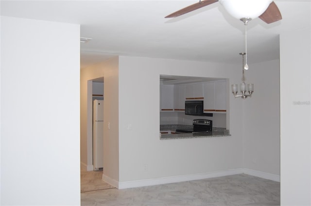 kitchen featuring white refrigerator and electric range